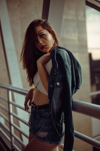 Standing Woman Leaning on Metal Railing