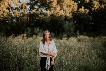 standing woman smiling near trees at daytime