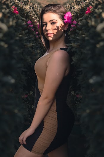 Standing Woman Wearing Black and Brown Striped Sleeveless Dress