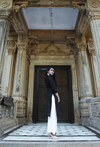 Standing Woman Wearing Black Long-sleeved Shirt and White Pants