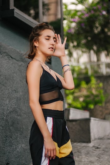 Standing Woman Wearing Black Spaghetti Strap Crop Top