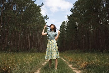 Standing Woman Wearing Blue And Yellow Floral Skirt