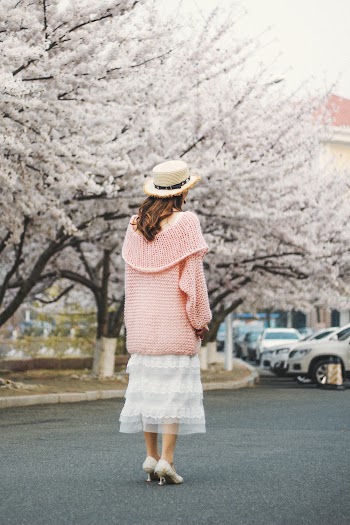 Standing Woman Wearing Pink Jacket and White Dress