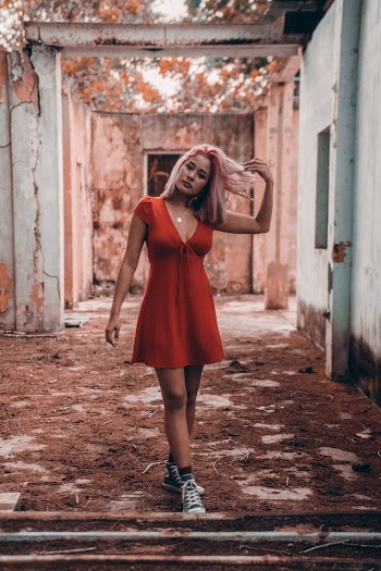 Standing Woman Wearing Red V-neck Dress Flipping Hair
