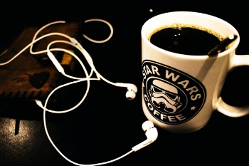 Star Wars Ceramic Mug Filled With Black Liquid With White Canal Buds Beside It