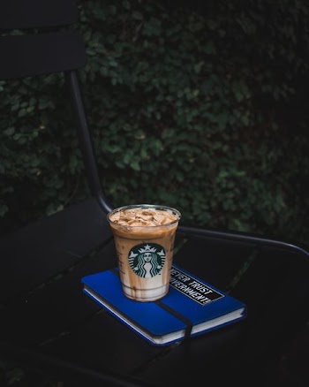Starbucks plastic cup on blue book