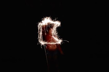 steel wool photography of man holding fireworks