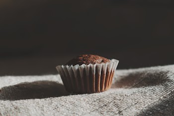 Still Life Photography of Muffin on White Textile