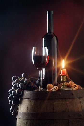Still life with red wine and candle