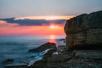 stone formation beside body of water