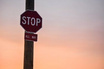 Stop Signage Under Orange Sky