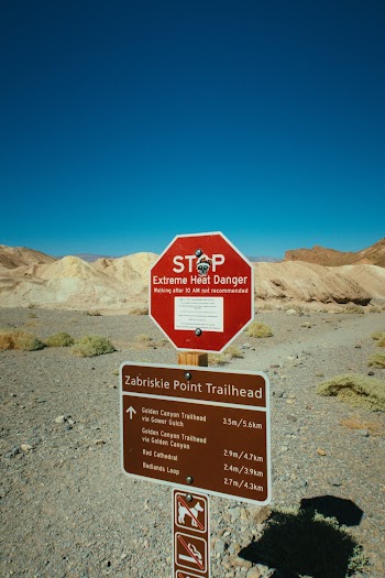 Stop Signboard on Rocky Field