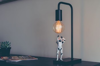 Storm Trooper vinyl figure under desk lamp