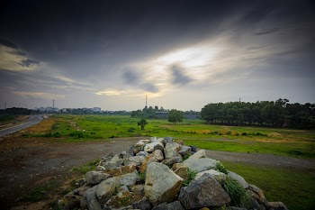 Stratus Clouds Above Green Grass and Beige Stones