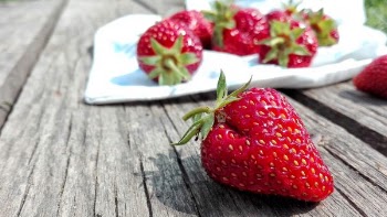 Strawberries on Top of Brown Table