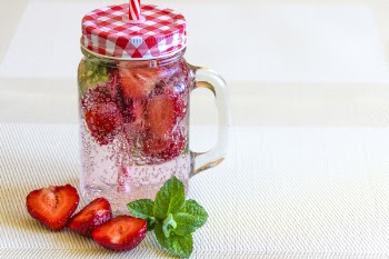 Strawberry Fruits Sliced in Half Near Clear Glass Container