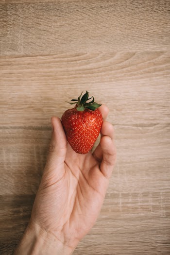 Strawberry in a male hand