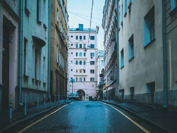 Street Alley With Assorted-color Concrete Buildings