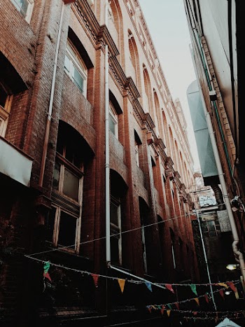 Street With Buntings in Between Brick Buildings