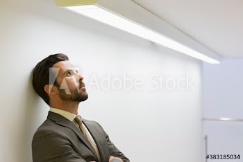 Stressed corporate businessman looking up