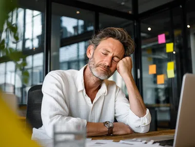 Stressed Professional at Modern Office Desk Stressed Professional at Modern Office Desk