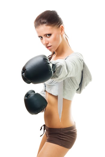 Strong concentrated woman shoots a straight right hand, isolated on white