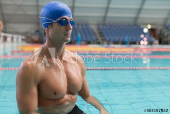 Strong male swimmer practicing in swimming pool