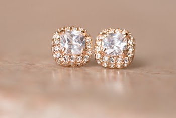 Stud Earrings On Beige Surface