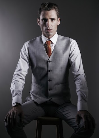 Studio Photo of Man in Formal Wear Sitting on Stool