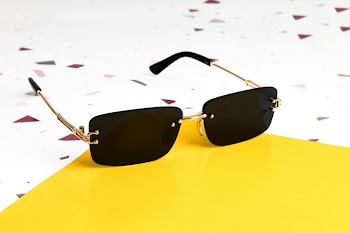 Stylish Black Sunglasses on a Bright Yellow Background