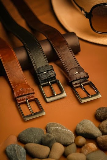 Stylish Leather Belts Displayed on a Rustic Surface