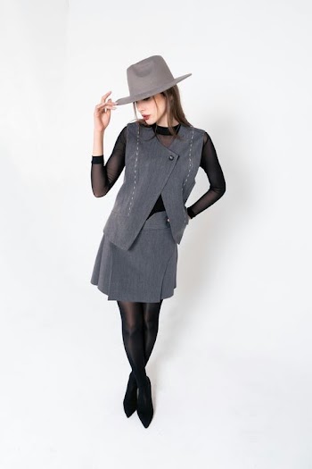 Stylish Woman in Grey Outfit with Hat