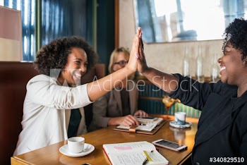 Succesful businesswomen giving a high five