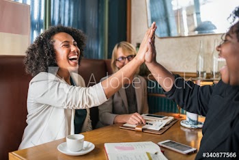 Succesful businesswomen giving a high five