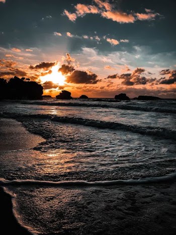 sunlight covering clouds over sea
