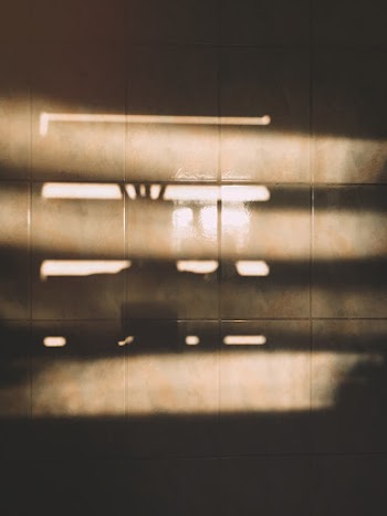 Sunlight Passing Through Window Reflection on Brown Tiled Surface
