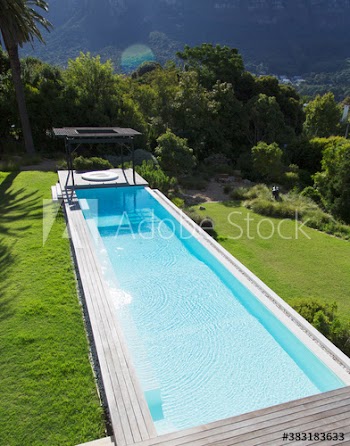 Sunny luxury lap swimming pool and hot tub