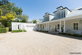 Sunny luxury modern home showcase exterior and driveway