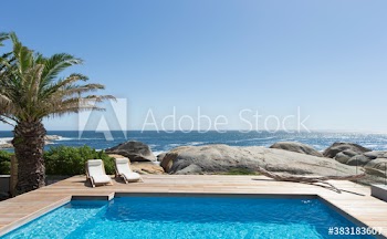 Sunny luxury swimming pool with ocean view