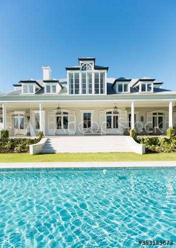 Sunny swimming pool and luxury home showcase exterior