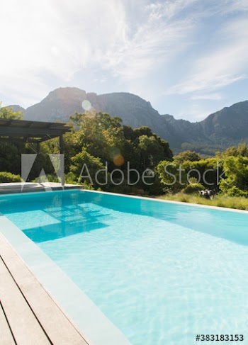 Sunny swimming pool with scenic mountain view