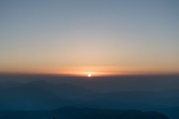sunrise in front of mountain