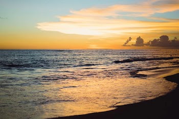 Sunset on the ocean. beautiful bright sky, reflection in water, waves.