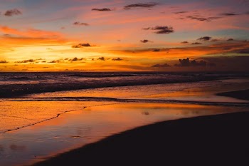 Sunset on the ocean. beautiful bright sky, reflection in water, waves.