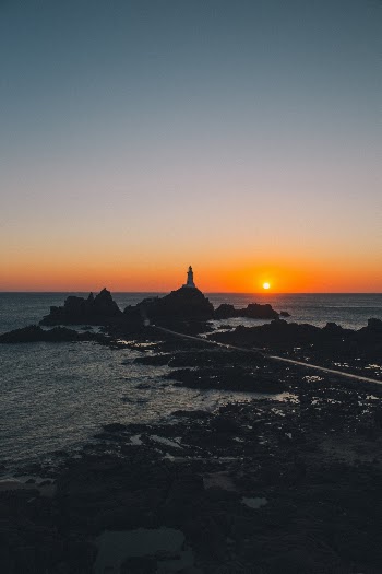 Sunset over a lighthouse in Jersey 