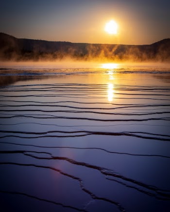 Sunset over Grand Prismatic Spring in Yellowstone National Park, Wyoming, USA.