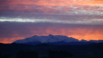 sunset over snow-cover mountain range