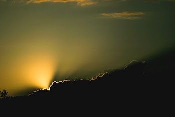sunshine through clouds during sunset