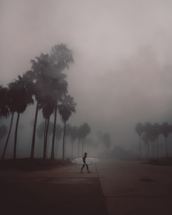 Surfer Walking on Road