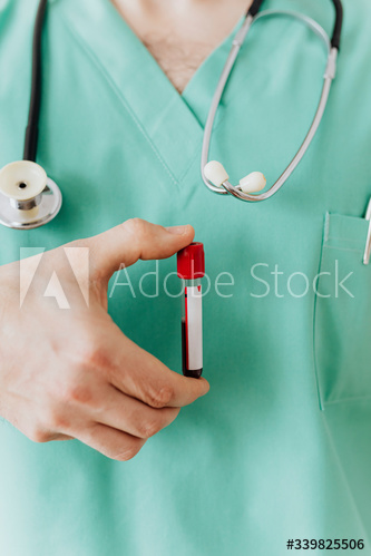 Surgeon holding a blood test tube